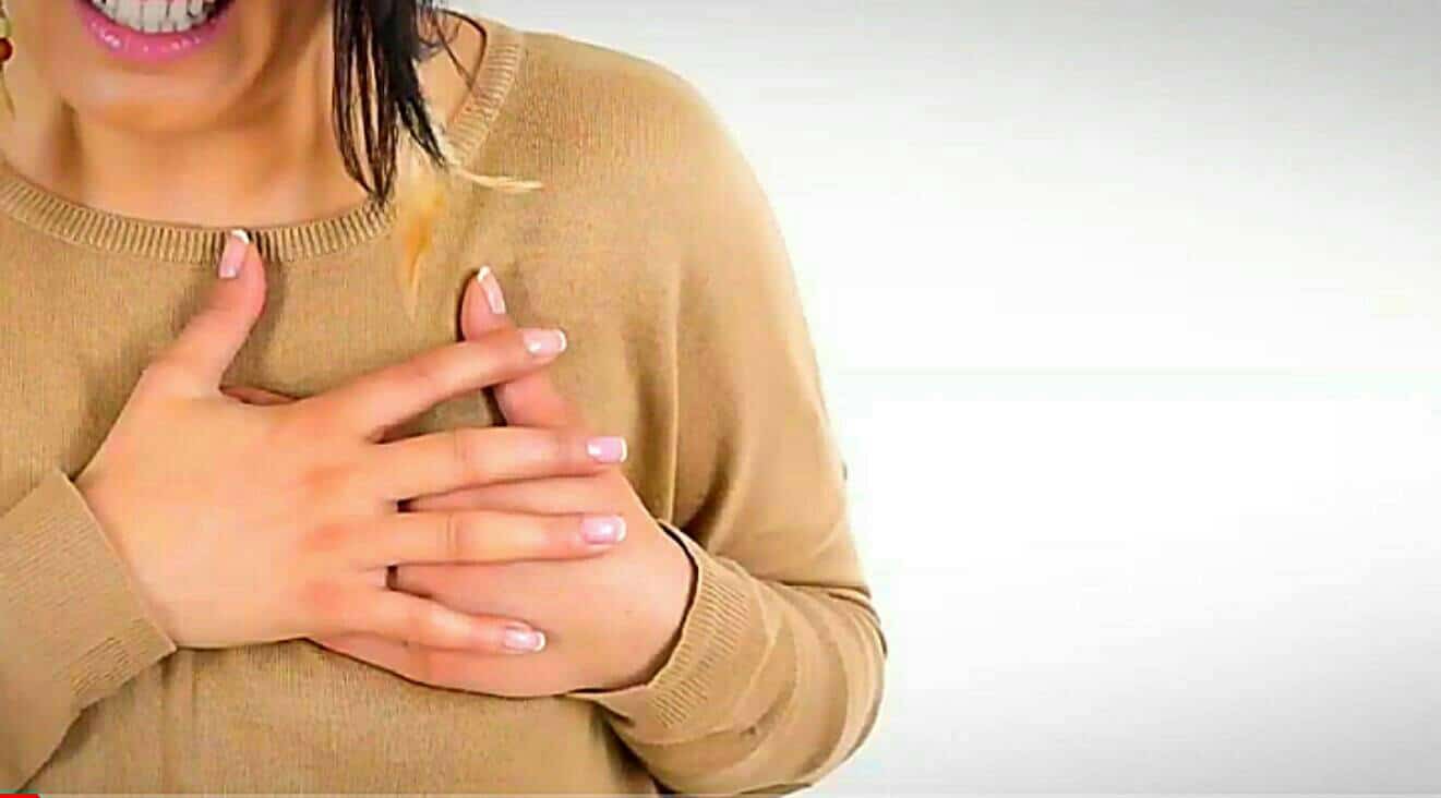 A woman having chest pain as a result of the side effects of smoking dabs